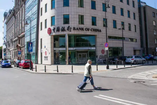 Photo taken shows a passerby walking in front of the Poland branch of the Bank of China in Warsaw, the country’s capital city. Officially started operation on June 6, 2012, the bank has had full access to the financial market of Poland, providing high-quality financial services for Chinese and Polish clients from the industrial, commercial and financial sectors as well as for individual customers. Its services include deposit, loan, remittance of local and foreign currencies, foreign exchange transactions, trade finance, and guarantee, etc. The branch is the first Chinese bank officially operating in Poland. (Photo by Xinhua News Agency)
