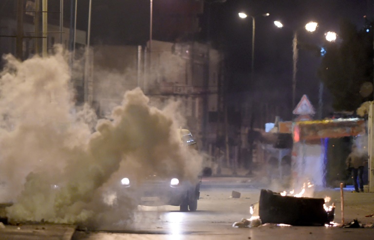 Les forces de sécurité tunisiennes recherchent des protestaires à Ettadhamen, dans la banlieue de Tunis le 10 janvier 2018 / © AFP / FETHI BELAID