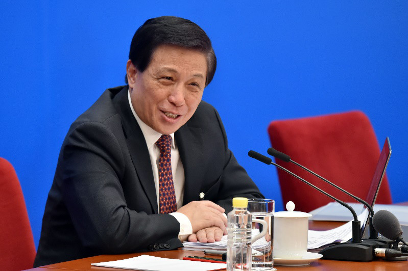 Zhang Yesui, spokesperson for the first session of the 13th National People's Congress (NPC), answers questions during a press conference on the NPC session in Beijing, March 4, 2018. (Photo by Weng Qiyu from People’s Daily Online)