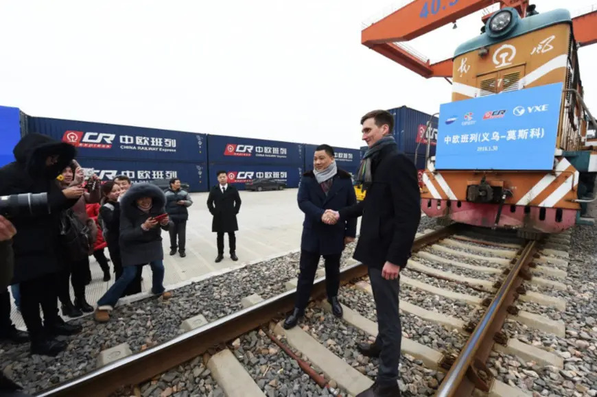Photo shows the Chinese and Russian operators of a China-Europe freight train who are giving interviews to media. The freight train, loaded with 100 standard containers of small commodities, left Yiwu, Zhejiang province, Jan. 30, 2018. It would travel 10,150 km via Manzhouli, Inner Mongolia Autonomous Region and reach Moscow in about 13 days. (Photo by Gong Xianming from CFP)