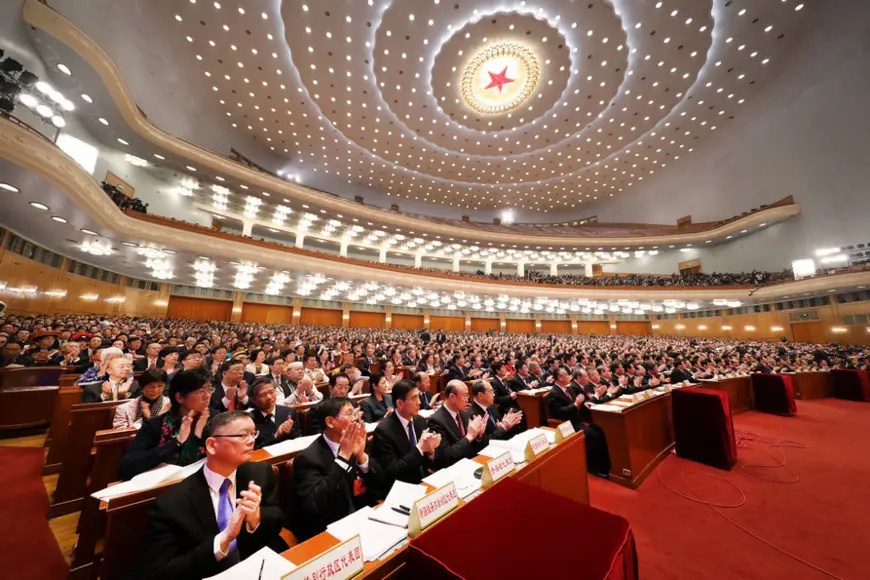Deputies to the 13th National People's Congress (NPC) listen to an institutional restructuring plan of the State Council at the fourth plenary meeting of the first session of the 13th NPC at the Great Hall of the People in Beijing on March 13, 2018. (Photo by Li Ge from People’s Daily)