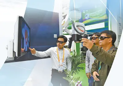 A visitor experiences intra-operative visual magnification system at the exhibition area for medical equipment and medical care products. Photo by Chen Bin from People’s Daily