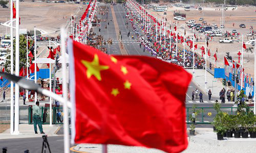 A Chinese national flag flies in front of a Chinese-built road before a welcome ceremony for Chinese President Xi Jinping ahead of the APEC Summit in Port Moresby, Papua New Guinea on Friday. Photo: VCG