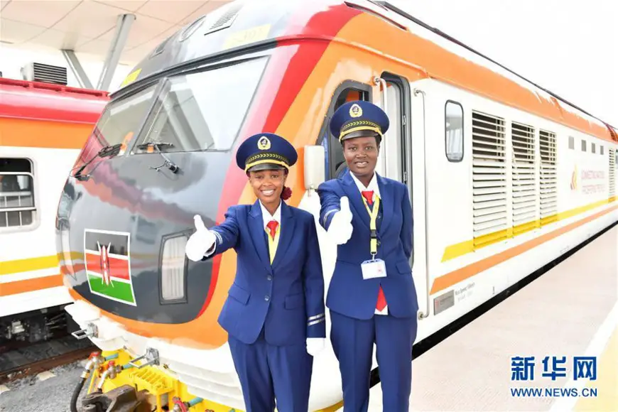 Two female engine drivers gesture before the operations of the Mombasa-Nairobi Standard Gauge Railway in Mombasa, Kenya to wish a successful journey of the first train. (Xinhua/Sun Ruibo)