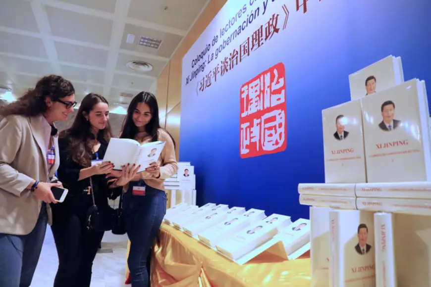 Three Spanish readers are reading Xi Jinping: The Governance of China at the sharing session. Photo by Han Xiaoming from People’s Daily