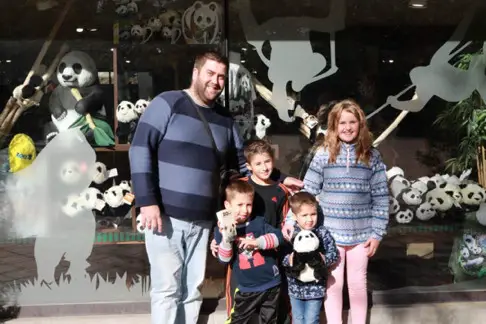 Local visitors take pictures with toy pandas. Photo by Bai Yang from People’s Daily