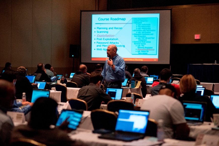 Participants listen to a global cyber security practitioner at a SANS training session.