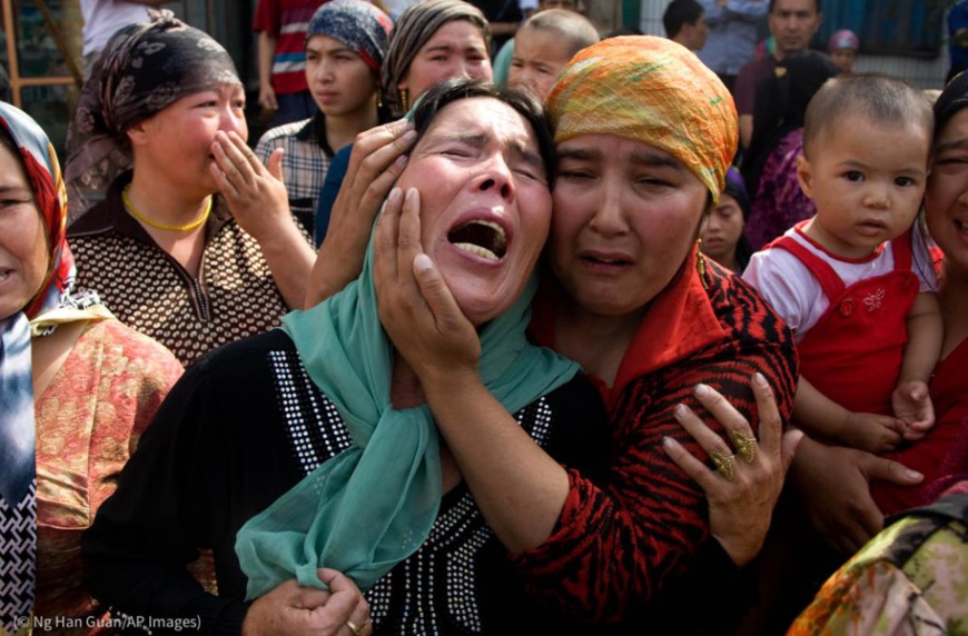 Des femmes ouïgoures affligées suite à une série d’arrestations à Xinjiang, en Chine. (© Ng Han Guan/AP Images)