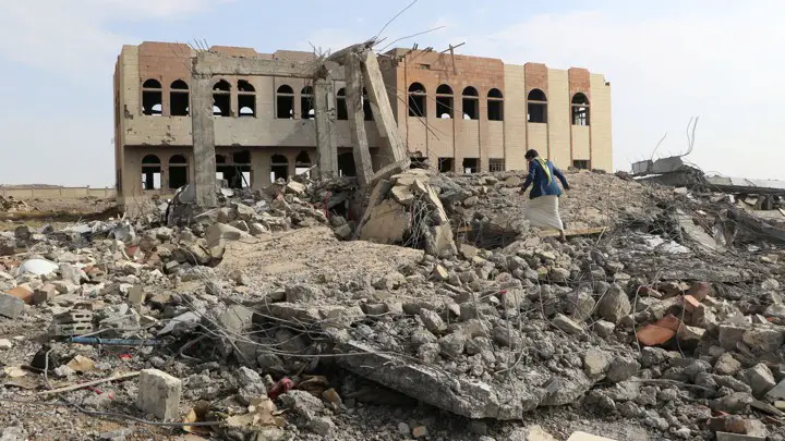 A man walks through the rubble of an air strike on a college in Saada, Yemen.NAIF RAHMA / REUTERS