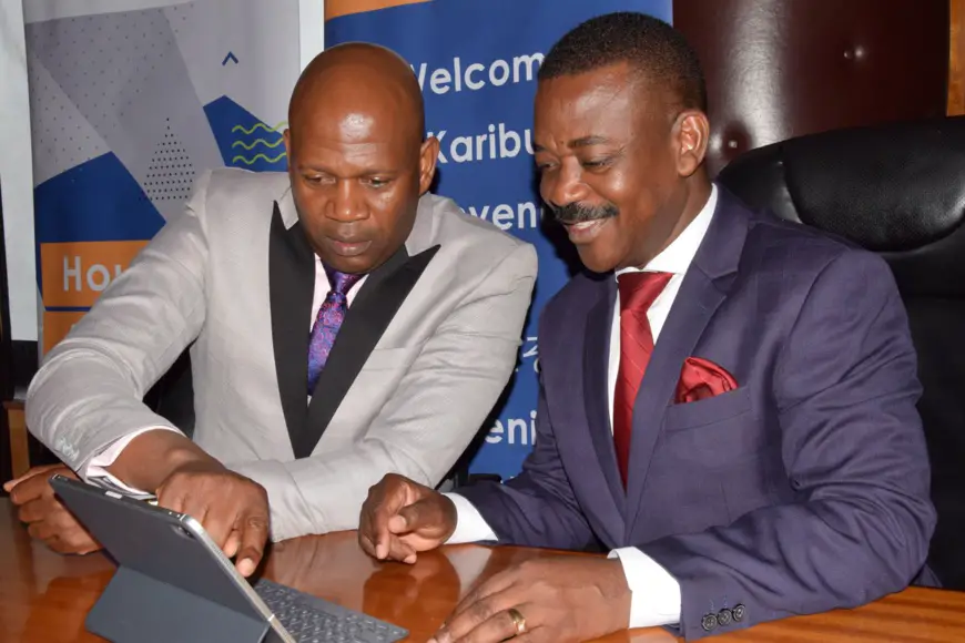 Shelter Afrique Managing Director Andrew Chimphondah (left) explains financials results to Shelter Afrique Chairman Nghidinua Daniel when the Company released its 2019 half year result last month.