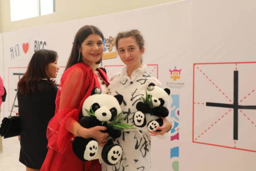 Greek citizens hold panda toys as they pose for a photo at a Chinese characters exhibition in Athens, Greece. (Photo by Hua Fang from People's Daily).