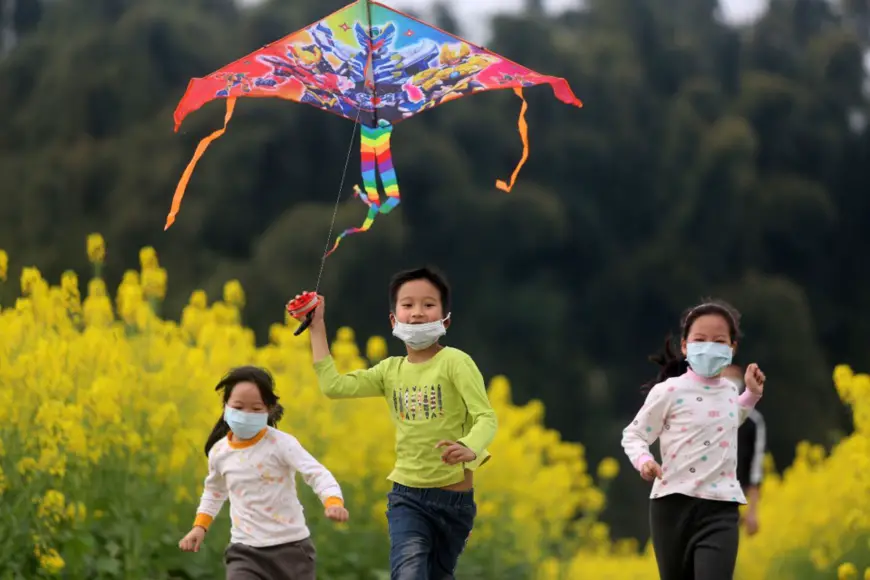 Children fly kites in flower fields of Jiangan Country, Yibin of Sichuan Province. The city canceled this year’s Spring Flower Festival due to the COVID-19 influence, but still getting ready for tourists. (Photo by Lan Feng/People’s Daily Online)
