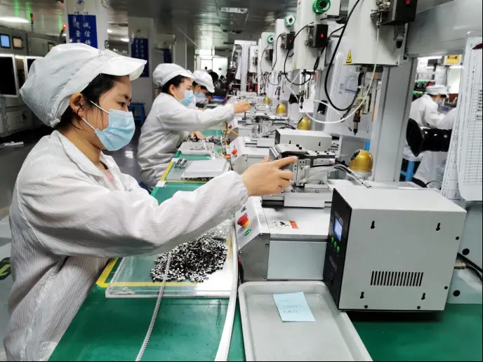Workers are busy at a factory of an electronics company in Leqing, a county-level city in Wenzhou, east China's Zhejiang province to complete orders for mini motors placed by foreign clients, March 10, 2020. Cai Kuanyuan/People’s Daily Online