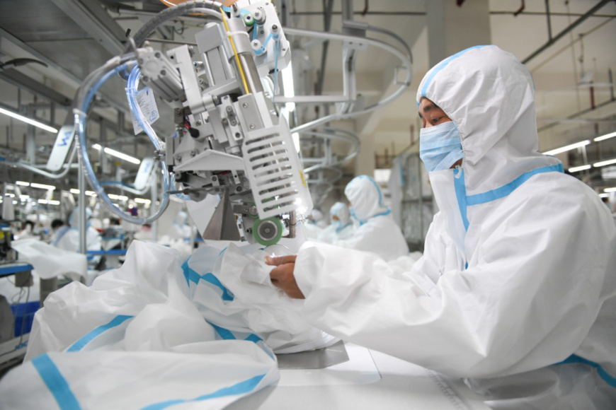 Employees of Hubei Ourselves Garment Co., Ltd., Qianjiang, Hubei province manufacture protective suits, March 25, 2020. The company can produce 8,000 protective suits per day which are exported to the U.S., Japan, South Korea and the European Union. Photo by Wu Yanjun/ People’s Daily Online Employees of Hubei Ourselves Garment Co., Ltd., Qianjiang, Hubei province manufacture protective suits, March 25, 2020. The company can produce 8,000 protective suits per day which are exported to the U.S., Japan, South Korea and the European Union. Photo by Wu Yanjun/ People’s Daily Online