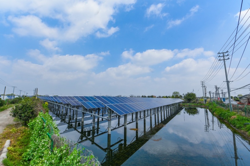 A harmonious picture of over 400,000 solar panels installed on the surface of a mulberry-dyke fish-pond which covers an area of over 4,200 mu (280 hectares) unfolds in Hefu town, Nanxun district, Huzhou city on March 24, 2020. The yellow rapeseed flowers beside the pond and the blue panels make a beautiful scene together. (Photo by Liu Chunhui, People’s Daily Online)