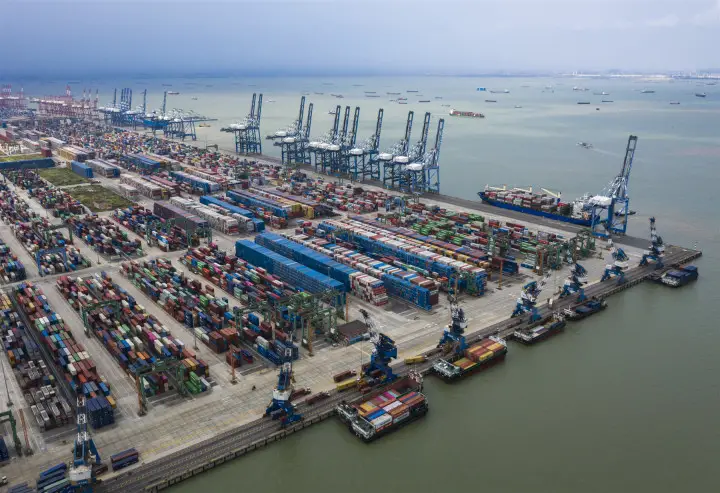 Photo taken on May 10 shows a busy scene at a container wharf of Longxue Island, Nansha district, south China’s city of Guangzhou. Photo by Qiu Xinsheng/People’s Daily Online