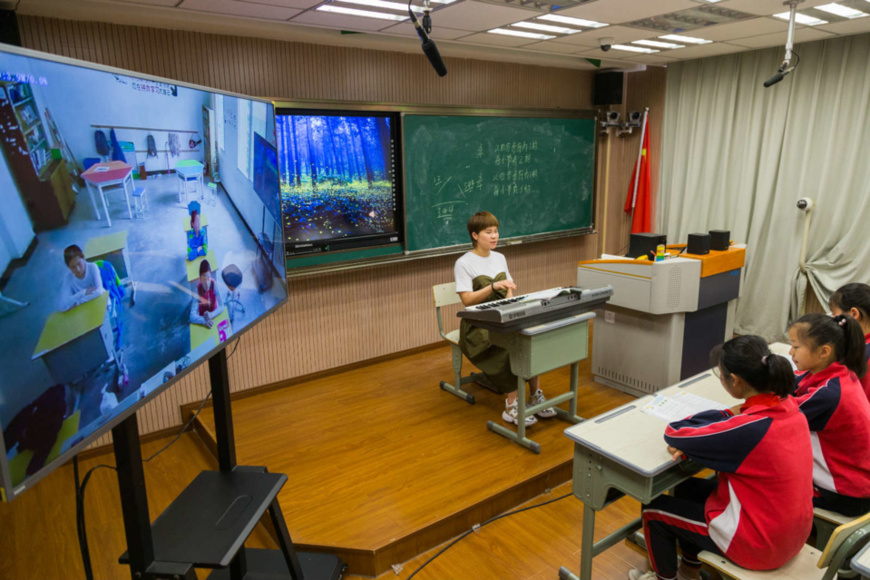 Primary school students in Changxing county, Huzhou, east China’s Zhejiang province attend a music class with their peers from a primary school in Lingtou township, Lishui, Zhejiang, via an online remote teaching platform, May 27. The pairing assistance given by the Changxing primary school to the rural school has boosted interconnectivity and the sharing of high-quality education resources. Photo by Xu Binhua/People’s Daily Online