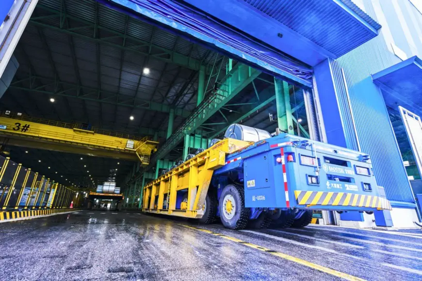 A self-driving heavy-load vehicle delivers materials in a production base in Baoshan of Baoshan Iron & Steel Co., Ltd. under China Baowu Steel Group Corp., Ltd., June 9. (Photo by Shi Cong, People’s Daily Online)