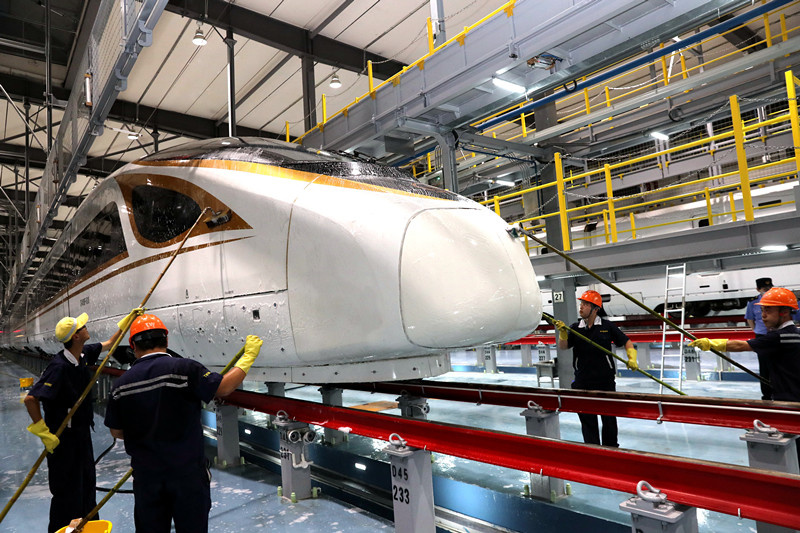 Staff members clean and check Fuxing and Hexie bullet trains running on the Shanghai-Suzhou-Nantong railway. The Nantong bullet train depot in Xingfu neighborhood, Gangzha district, Nantong, east China’s Jiangsu province is officially put into service on June 30, and two Fuxing bullet trains entered the depot for the first time on the same day. Photo by Xu Congjun/People’s Daily Online