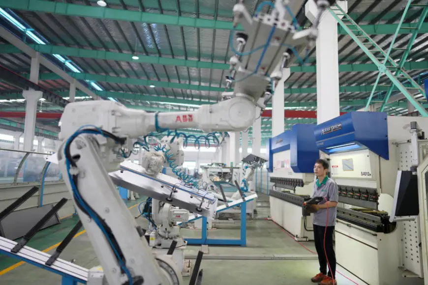 A worker controls a robotic arm at Gerson Elevator, Nanxun district, Huzhou, east China’s Zhejiang province, June 28. An elevator door, which requires 27 procedures, is now assembled by the company with only one employee, and the assembly time is 10 times faster than before. People’s Daily Online/Zhang Bin