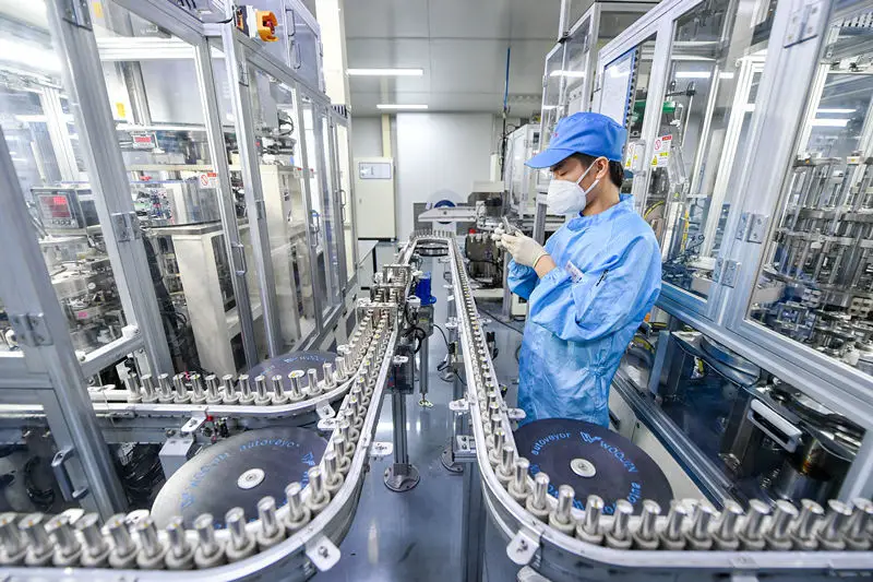 A worker manufactures lithium batteries on a production line of Tianneng Lithium-ion Battery, a new energy company in Changxing New Energy Town, Huzhou, east China's Zhejiang province, July 20.