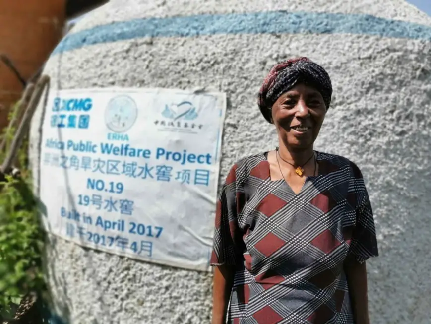 A local woman in Ghadaig Town, Amhara region, Ethiopia, takes a photo in front of a Chinese-funded water cellar. (Photo/Courtesy of XCMG)