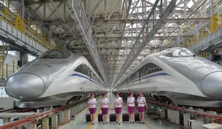 The attendants of a bullet train debuting on the Anshun-Liupanshui high-speed rail, Guiyang, capital of Guizhou on July 3. Photo by Qiao Qiming/People’s Daily Online