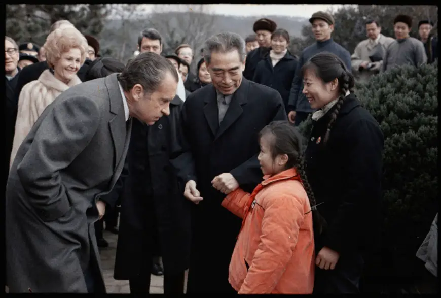 Chinese Premier Zhou Enlai and U.S. President Richard Nixon greet a young girl at Hangzhou West Lake park in China, February 26, 1972. (Photo from the website of the Richard Nixon Presidential Library and Museum)