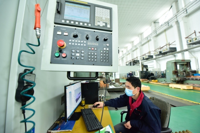 A researcher named Fei Qiang works on the research and development of the ITER correction coil box in a company in Hefei, capital of East China’s Anhui Province on Feb. 19. Photo by Ge Yinian/People’s Daily Online