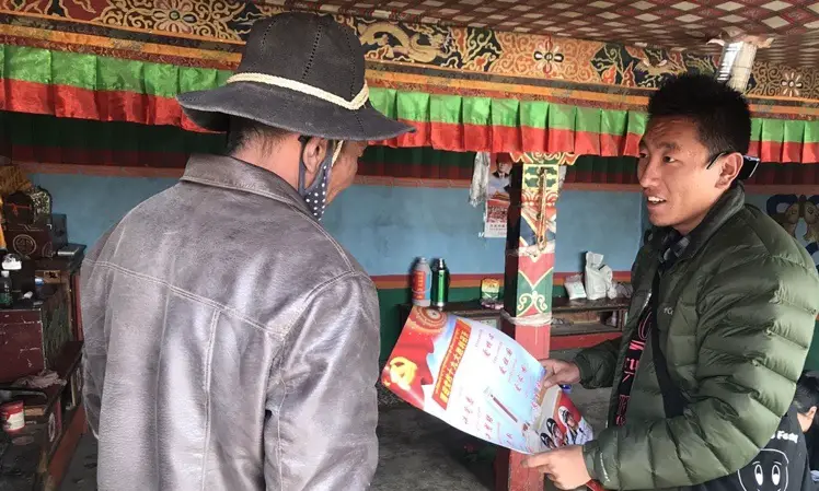 Tsering Tarchin, a poverty-alleviation official, explains national policies and guidelines to villagers in Ali prefecture in Southwest China's Tibet Autonomous Region. Photo: Courtesy of Tsering Tarchin
