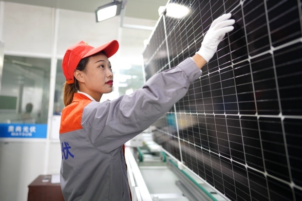 Photovoltaic panels are being fabricated at ZheJiang Maysun solar Co., Ltd. in Huzhou, east China's Zhejiang province, Oct. 14, which are expected to shipped to Germany. Photo by Zhang Bin/People's Daily Online