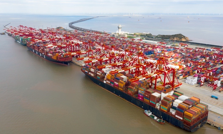 Vessels are busy handling cargos at the Yangshan Deep Water Port, Shanghai, Oct. 25. Photo by Ji Haixin/People's Daily Online