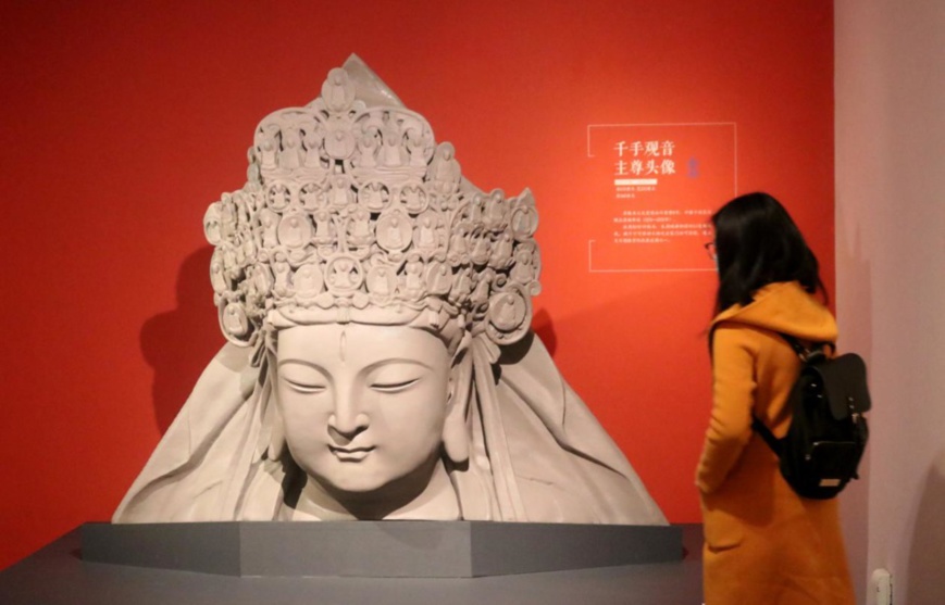 Photo shows a visitor appreciate artwork from the Dazu Rock Carvings scenic area in southwest China’s Chongqing municipality, at Suzhou Museum in Suzhou, east China’s Jiangsu province, Jan. 31. (Photo by Wang Jiankang/People’s Daily Online) Photo shows a visitor appreciate artwork from the Dazu Rock Carvings scenic area in southwest China’s Chongqing municipality, at Suzhou Museum in Suzhou, east China’s Jiangsu province, Jan. 31. (Photo by Wang Jiankang/People’s Daily Online)