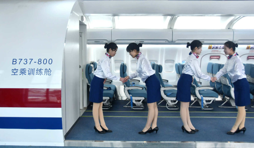 Students attend an airline etiquette class at a vocational education center in Yongnian district, Handan, north China's Hebei province, Nov. 26, 2020. (Photo by Hu Gaolei/People's Daily Online)