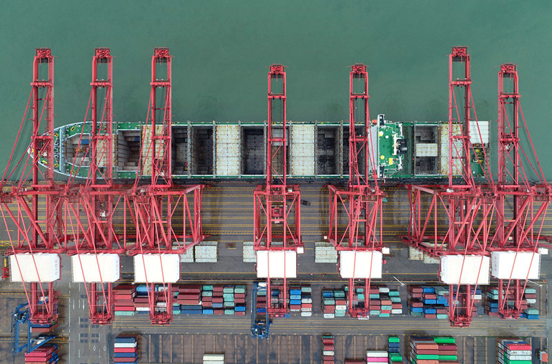 An oceangoing freighter is being loaded with cargos at a container terminal of Lianyungang Port, east China's Jiangsu Province, Aug. 7, 2020. (Photo by Wang Jianmin/People's Daily Online)