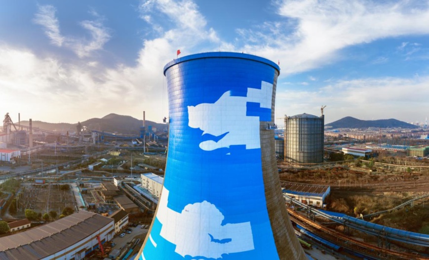 Photo taken on Jan. 14, shows workers decorating a cooling tower for a combined-cycle power plant (CCPP) project undertaken by Magang (Group) Holding Co., Ltd., a holding company of China’s largest steel producer, China Baowu Steel Group Corporation Limited (China Baowu). The CCPP project, which mirrors the efforts of China Baowu to promote green and low-carbon development, can reduce the consumption of 138,200 tons of standard coal per year. (Photo by Zhang Mingwei/People’s Daily Online)