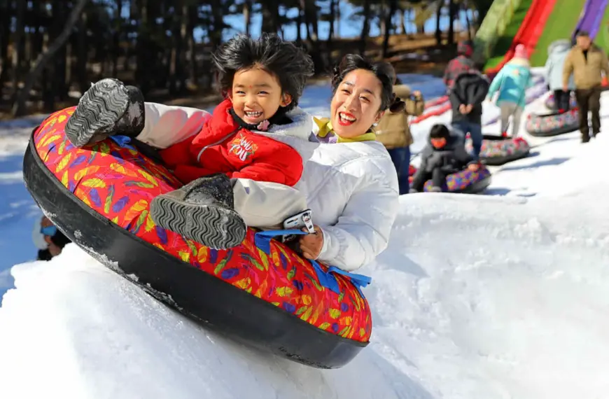 Visitors experience snowtubing at a scenic spot in Haigang District, Qinhuangdao, north China's Hebei Province, Feb. 15, 2021. (Photo by Cao Jianxiong/People's Daily Online)