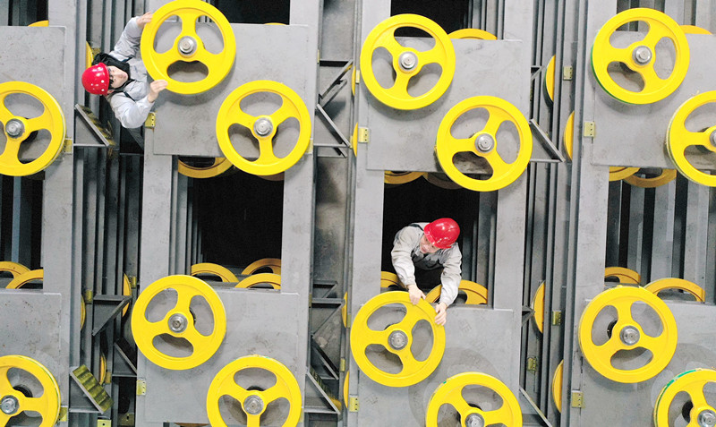 Workers check hot rolled steel components at a workshop of a tech firm in Deqing County, Huzhou, east China’s Zhejiang Province, March 8, 2021. (Photo by Xie Shangguo/People’s Daily Online)