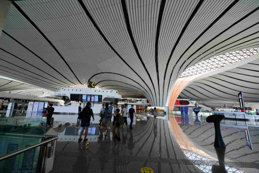 Photo taken on July 30, 2020 shows that passengers walk at Beijing Daxing International Airport. Photo by Fan Jiashan/People’s Daily Online