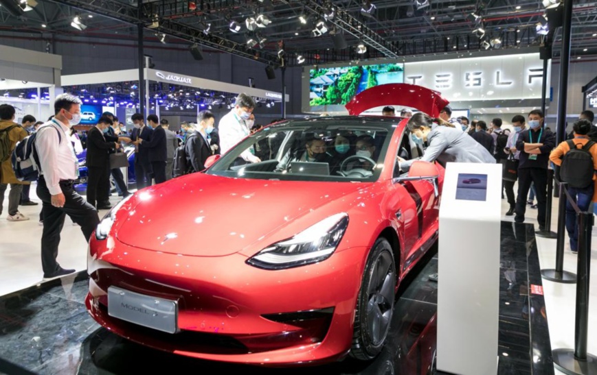 Visitors are attracted to a Tesla Model 3 electric car exhibited at the automobile exhibition area of the third China International Import Expo held in east China’s Shanghai, Nov. 6, 2020. (Photo by Zhai Huiyong/People’s Daily Online)