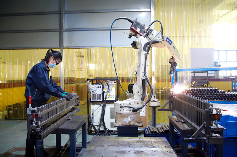 A worker is manufacturing parts of electric beds ordered by overseas clients at a workshop of a home tech firm in Nanxun District, Huzhou, east China's Zhejiang province, April 13, 2021. (Photo by Zhang Bin/People's Daily Online)