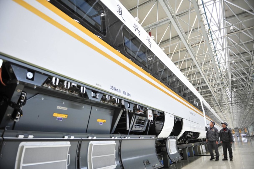 Engineers are tuning the braking unit of a Fuxing bullet train at CRRC Changchun. (Photo by Wang Wei/People's Daily Online)