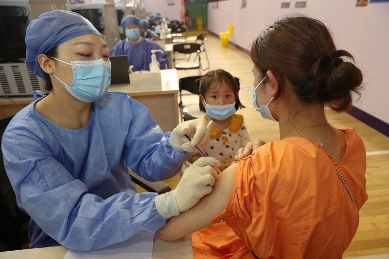 A woman receives a dose of COVID-19 vaccine in Chongzhou district, Nantong, east China's Jiangsu province, July 5, 2021. (Photo by Xu Congjun/People's Daily Online)