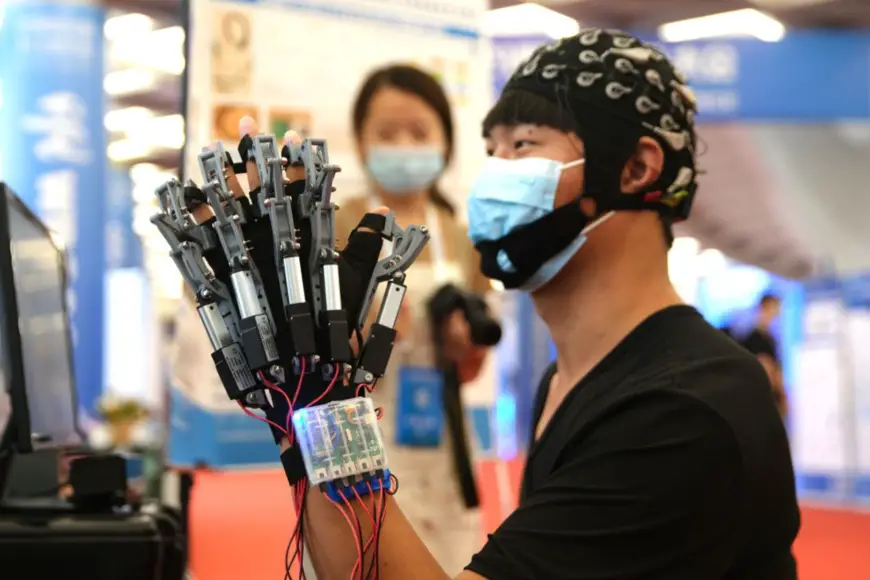 A hand rehabilitation robot is displayed at the 2021 World Robot Conference held in Beijing, Sept. 12, 2021. (Photo by Guo Junfeng/People's Daily Online)