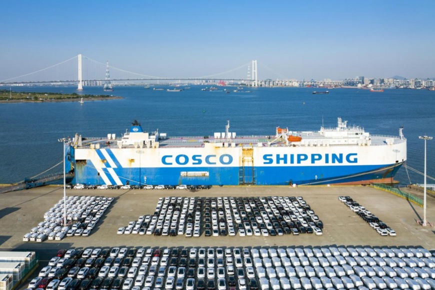 Automobiles are being loaded onto a vessel of China Ocean Shipping Company at a terminal in Guangzhou, south China's Guangdong province, Nov. 13, 2021. (Photo by Wei Jinsong/People's Daily Online)