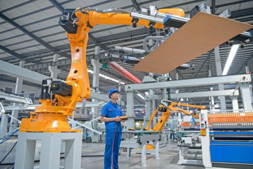 A technician debugs an automatic production device in a workshop of the Nantong Yuetong CNC Equipment Co., Ltd., Hai’an, east China’s Jiangsu province, May 24, 2021. (Photo by Jiang Ming/People’s Daily Online)