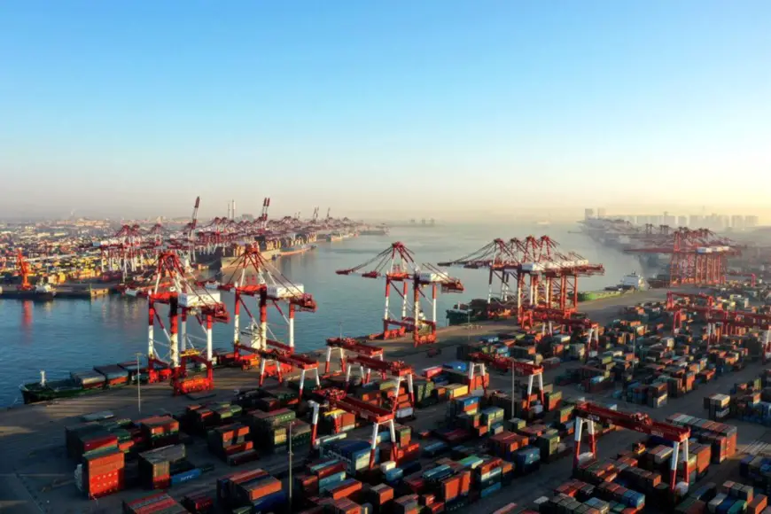 Photo taken on the morning of Dec. 31, 2021 shows a busy container terminal in Qingdao Port, east China’s Shandong province. (Photo by Han Jiajun/People’s Daily Online)