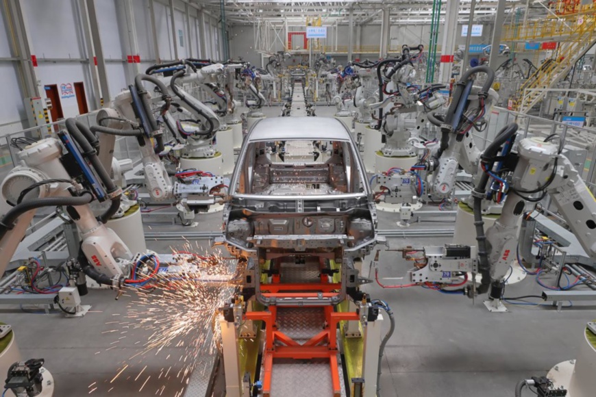 Photo taken on Jan. 14, 2022 shows smart mechanical arms welding the frame of a new-energy vehicle on a smart production line of a workshop of Dayun Automobile Co., Ltd. based in Yuncheng city, north China’s Shanxi province. (Photo by Yan Xin/People’s Daily Online)