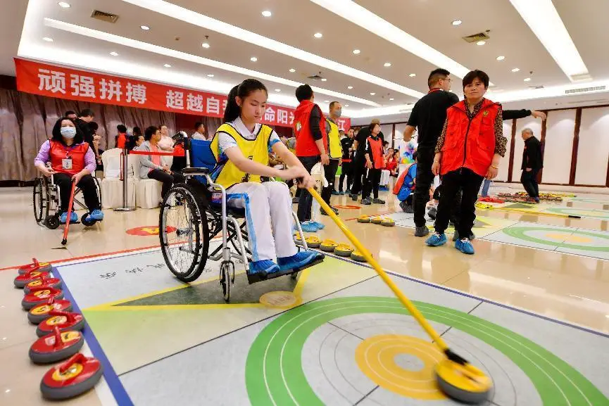 Photo taken on April 29, 2021 shows people with disabilities taking part in floor curling competition at the sports base of Changxing county, Huzhou city, east China’s Zhejiang province. (Photo by Tan Yunfeng/People’s Daily Online)