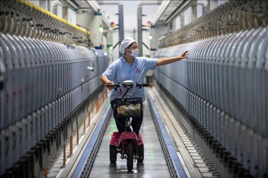A worker inspects air jet looms in a workshop of a textile company in Lanxi city, east China’s Zhejiang province. (Photo by Hu Xiaofei/People’s Daily Online) A worker inspects air jet looms in a workshop of a textile company in Lanxi city, east China’s Zhejiang province. (Photo by Hu Xiaofei/People’s Daily Online)